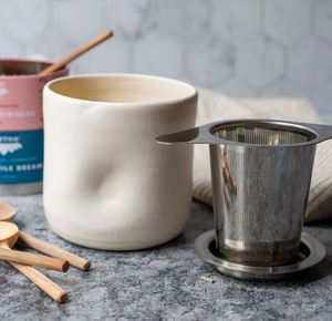 STAINLESS STEEL TEA STEEPER STRAINER SITS ON MUG